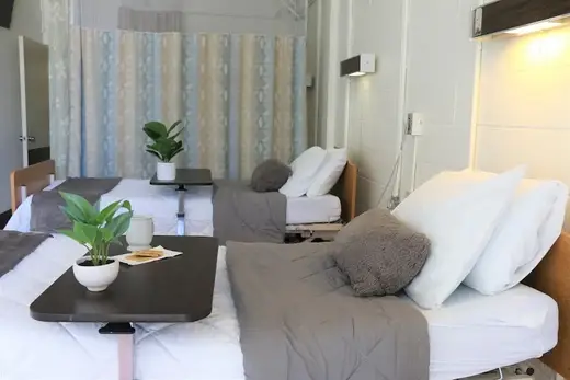 Cozy bedroom with two beds at The Care Center of Honolulu, a detox center in Hawaii.